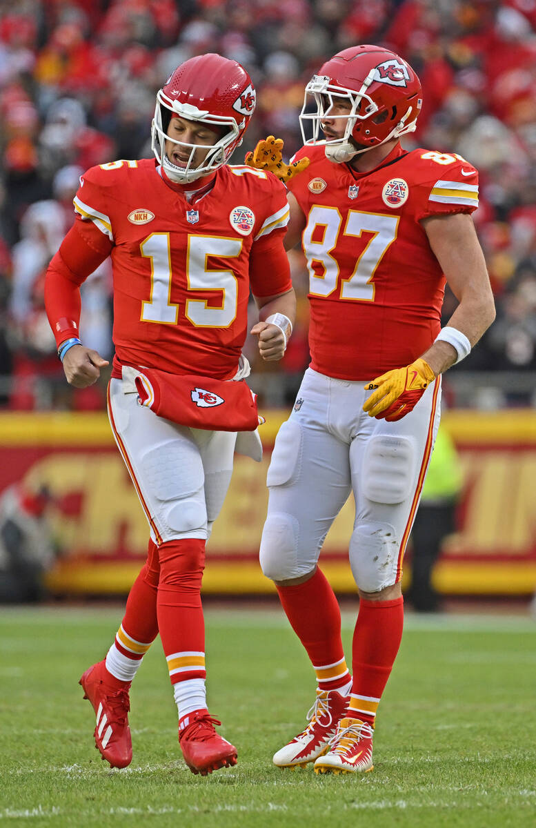 Kansas City Chiefs tight end Travis Kelce (87) pats quarterback Patrick Mahomes (15) on the sho ...