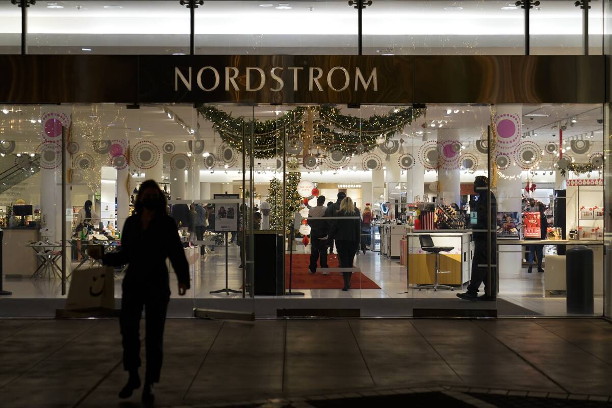 FILE - A security guard, right, stands at the entrance to a Nordstrom department store at the G ...