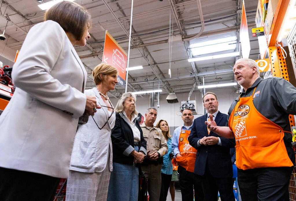 Larry Jensen, a store manager at the Home Depot, leads a tour of his store as Scott Glenn, vice ...