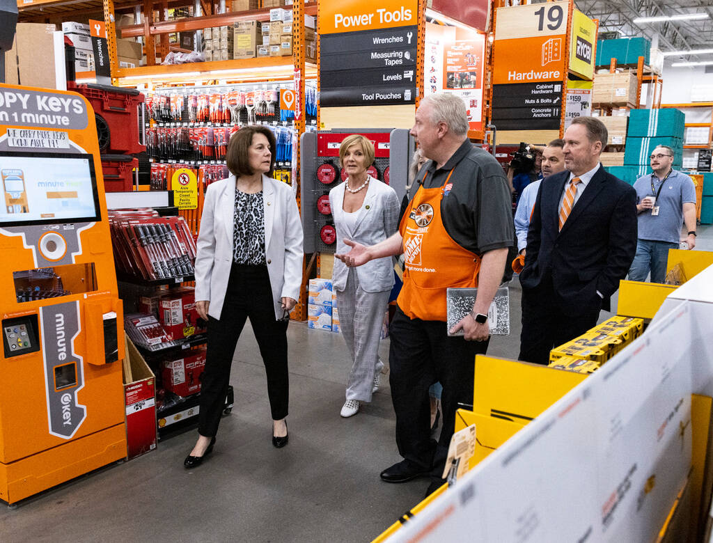 Larry Jensen, right, a store manager at the Home Depot, leads a tour of his store as Scott Glen ...