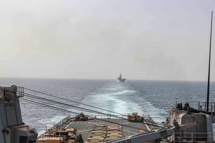 In this image provided by the U.S. Navy, the amphibious dock landing ship USS Carter Hall and a ...
