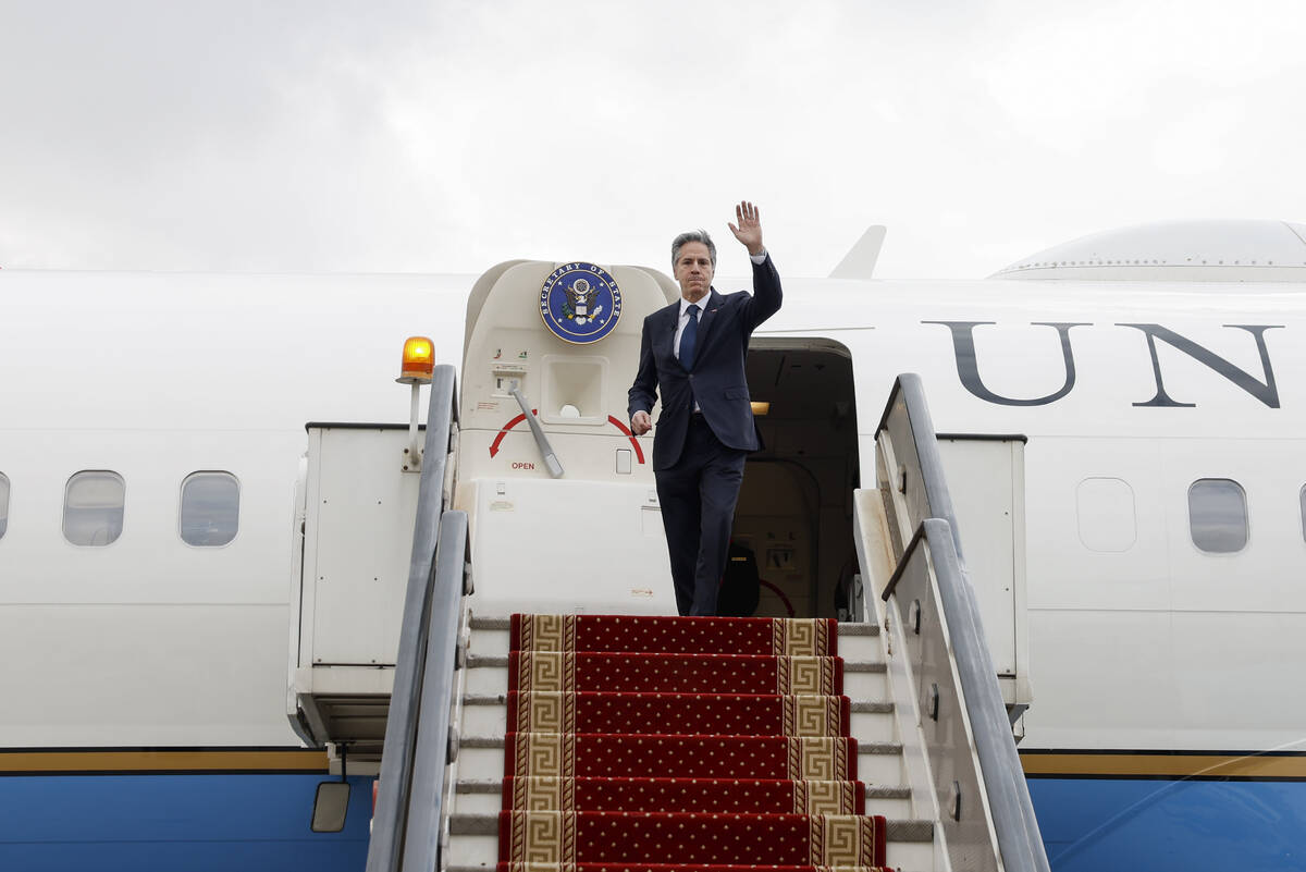 U.S. Secretary of State Antony Blinken waves as he boards his plane to return to Washington, fo ...