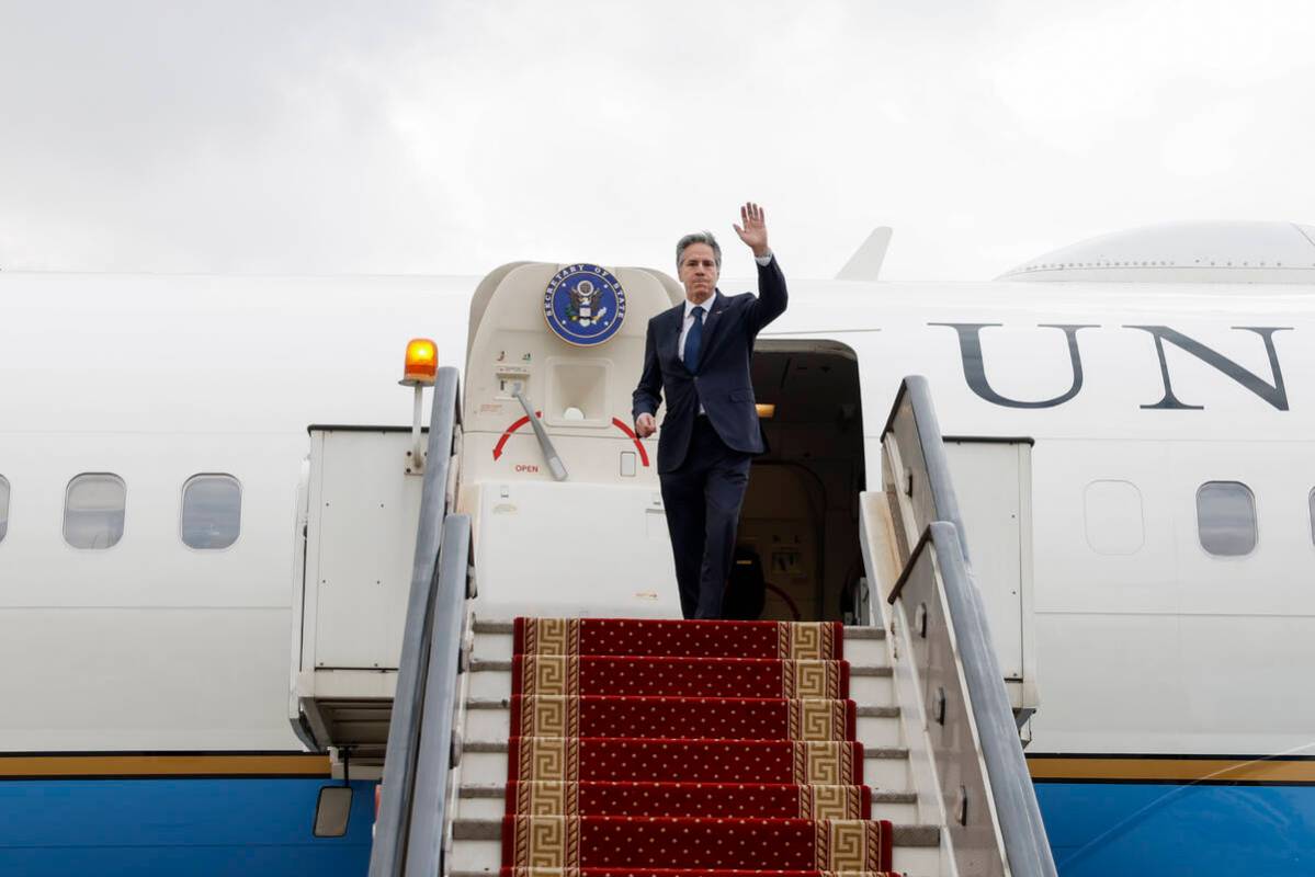 U.S. Secretary of State Antony Blinken waves as he boards his plane to return to Washington, fo ...