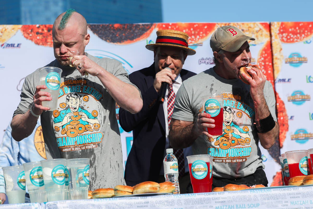 Nick Wehry, left, and Geoff Esper race to eat as many bagels with cream cheese as they can in e ...