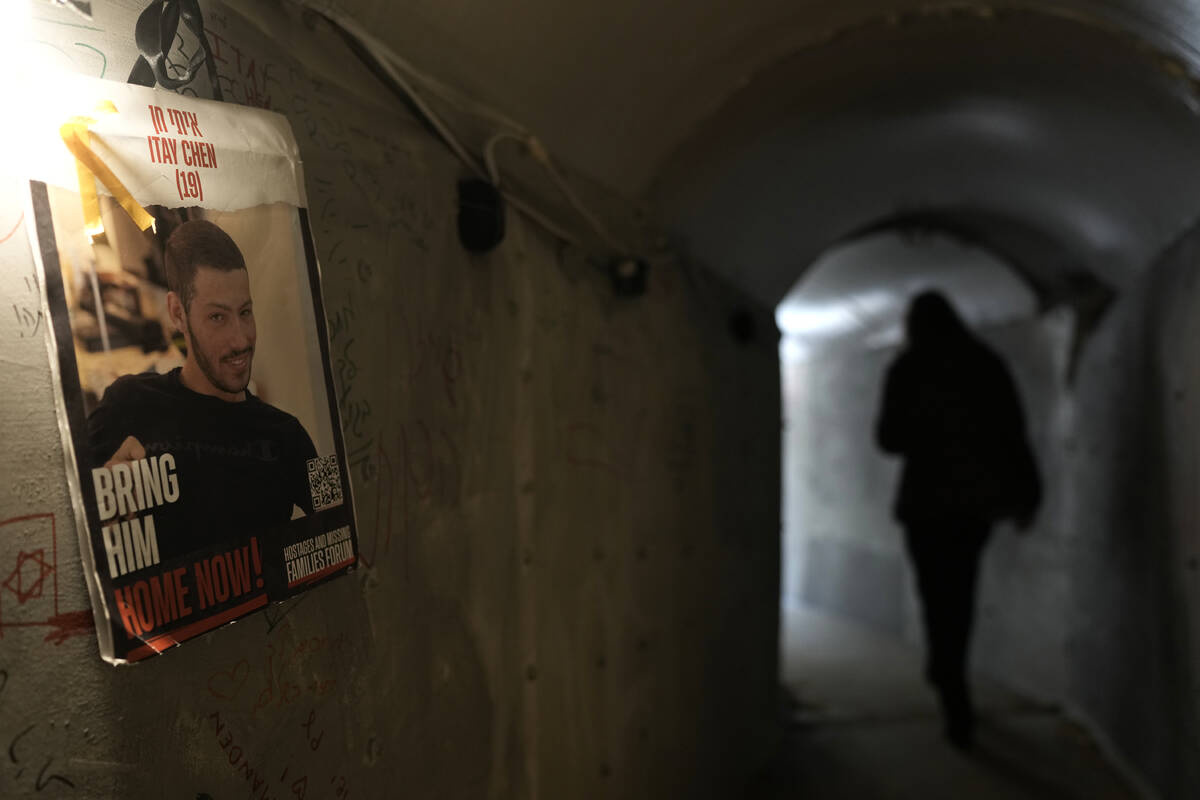 People walk through an installation simulating a tunnel in Gaza in an act of solidarity with ho ...