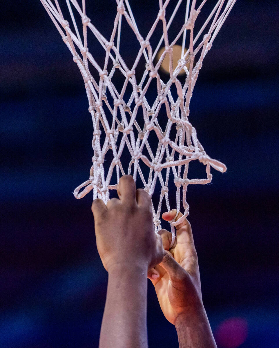 A player grabs the net momentarily as UNLV battles the Utah State Aggies during the second half ...