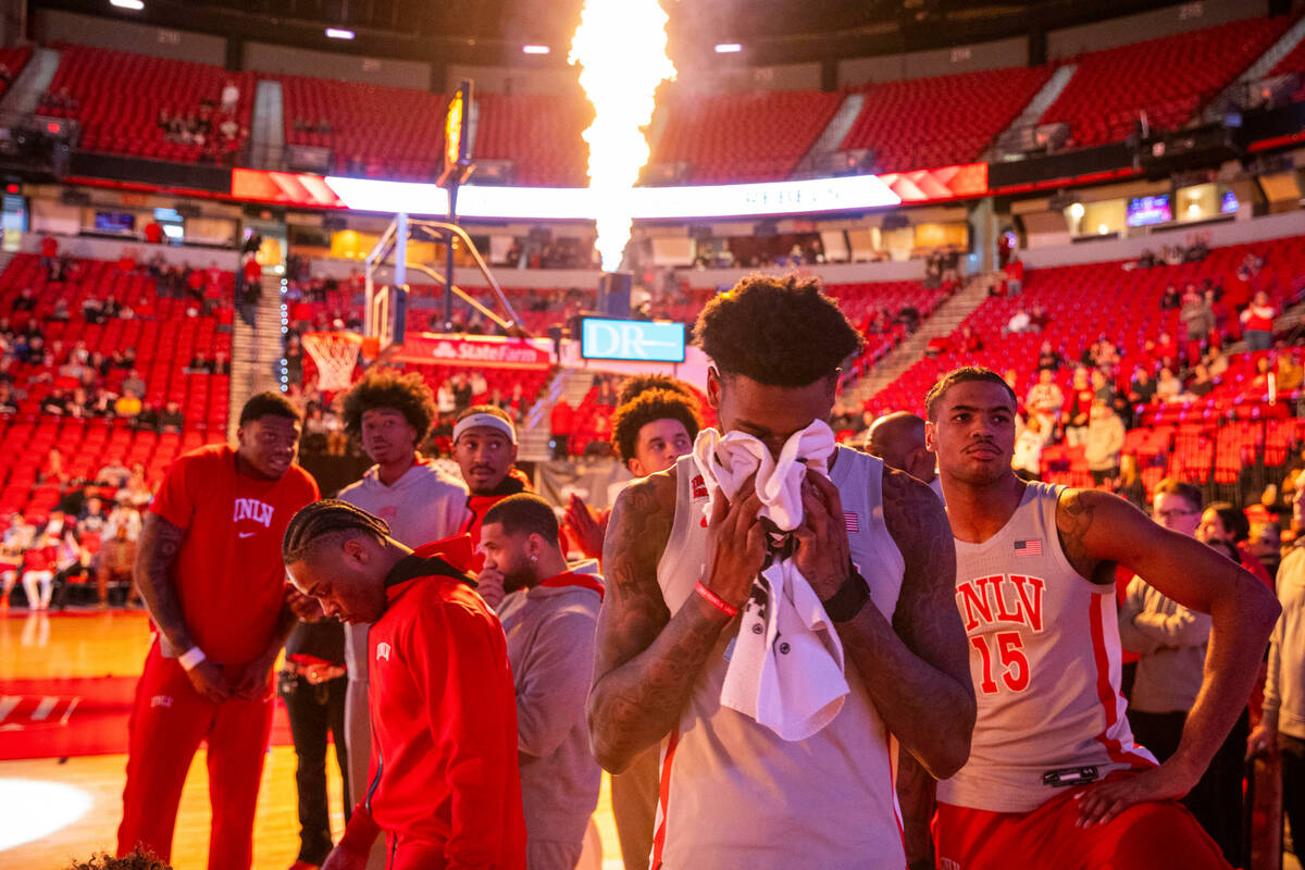 UNLV forward Kalib Boone (10) and teammates turn from the flame in pregame activities before fa ...