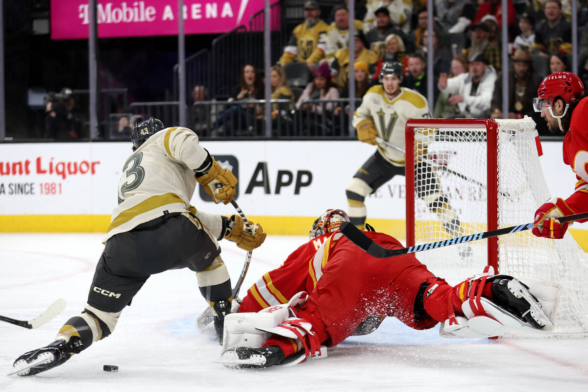 Golden Knights center Paul Cotter (43) misses the puck while attempting a goal onFlames goalten ...