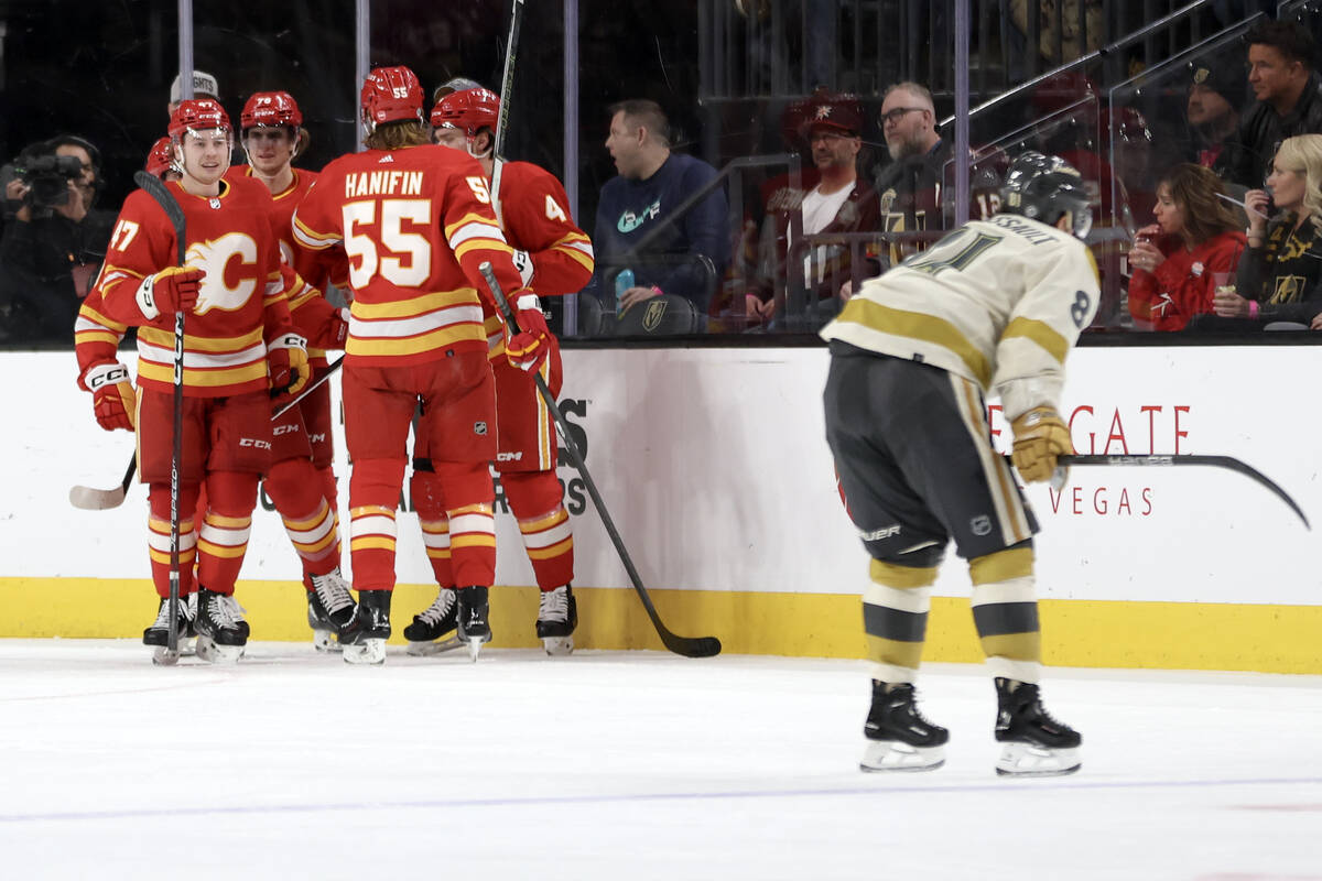 The Flames celebrate a goal while Golden Knights right wing Jonathan Marchessault, right, react ...