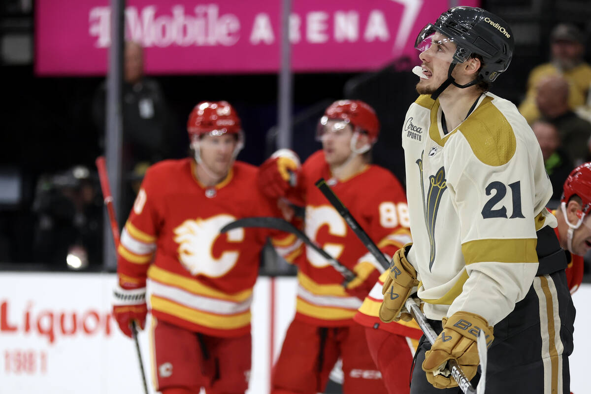 Golden Knights center Brett Howden (21) watches the replay of a Flames goal during the second p ...