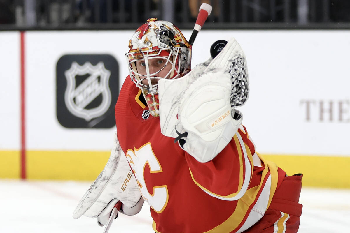 Flames goaltender Jacob Markstrom (25) makes a glove save during the third period of an NHL hoc ...