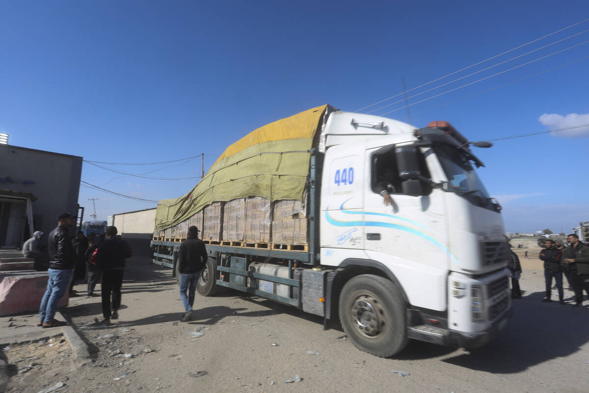 Humanitarian aid trucks enter the Gaza Strip from Israel through the Kerem Shalom crossing in R ...