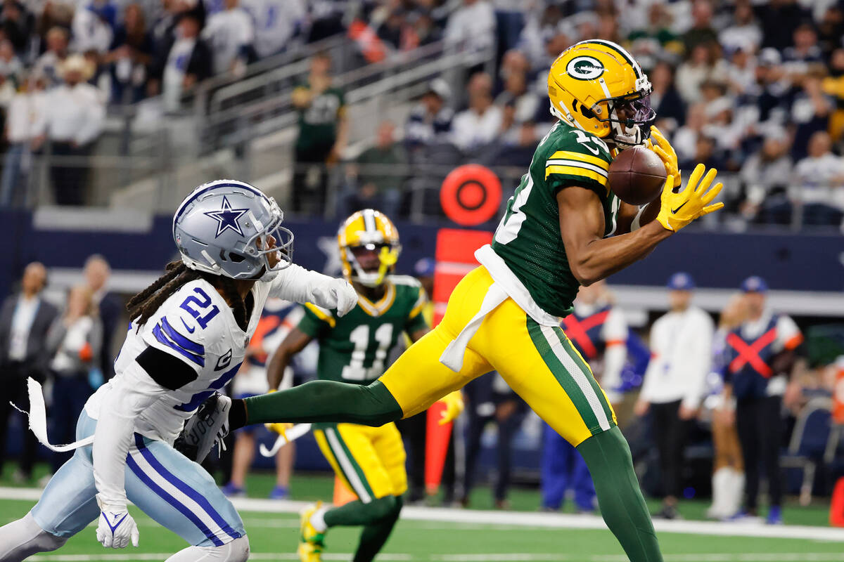 Green Bay Packers wide receiver Dontayvion Wicks, right, makes a touchdown catch in front of Da ...