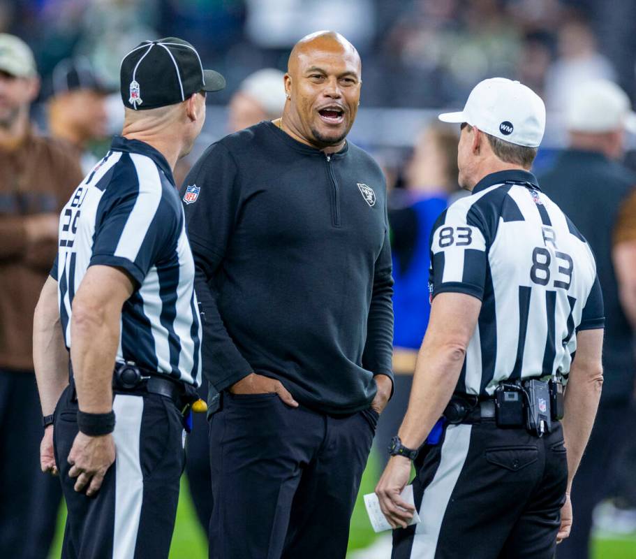 Raiders interim head coach Antonio Pierce talks with officials before the first half of their N ...