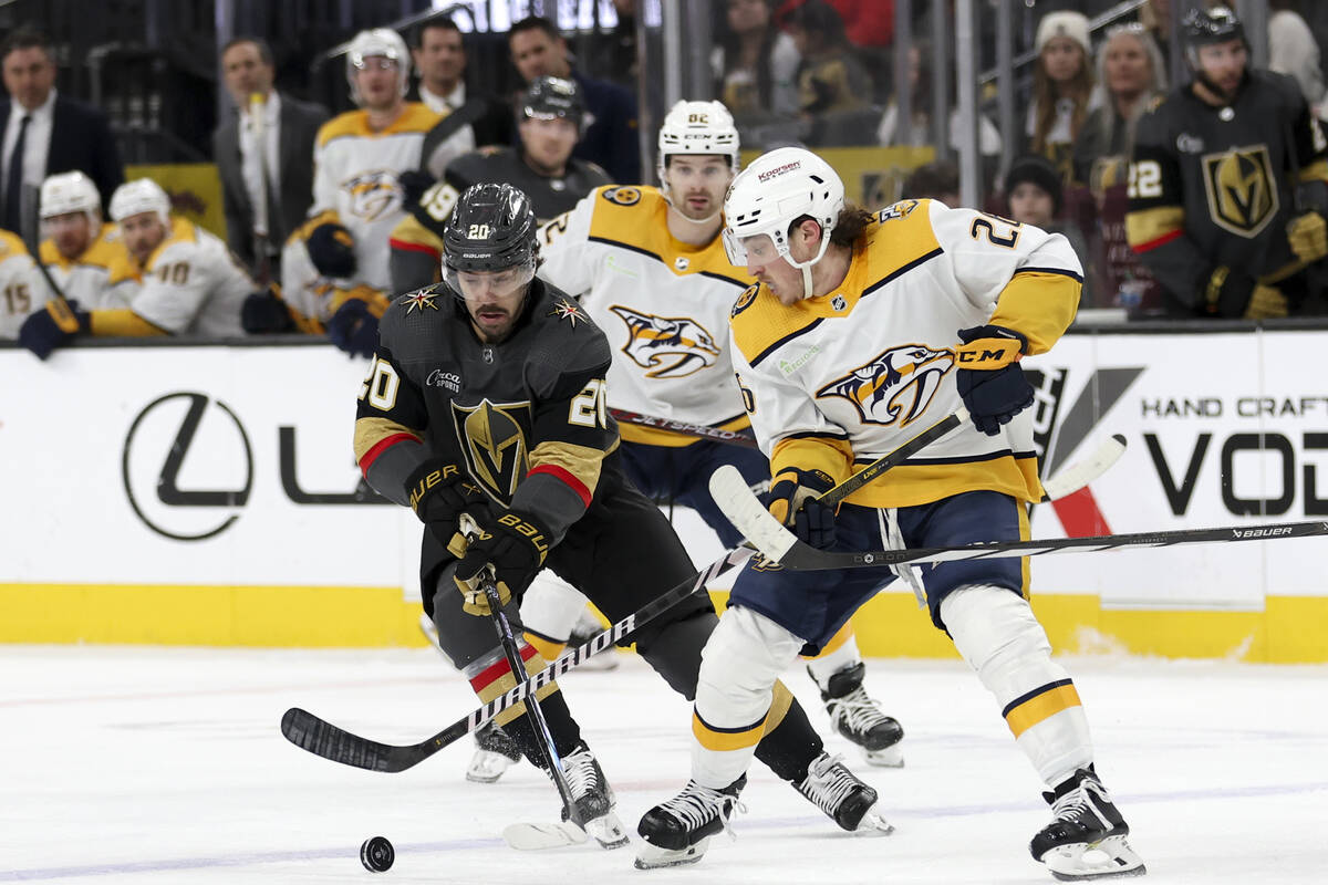 Vegas Golden Knights center Chandler Stephenson (20) battles for the puck with Nashville Predat ...