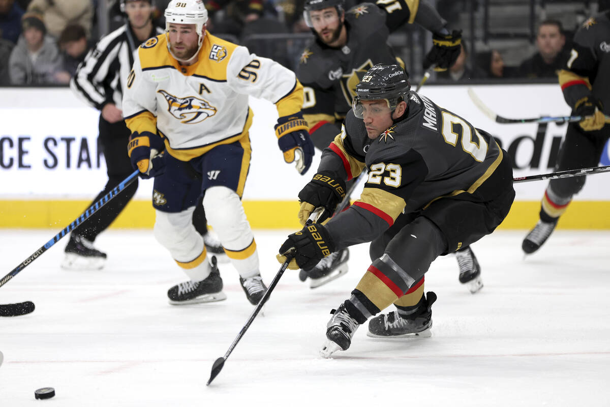 Vegas Golden Knights defenseman Alec Martinez (23) sends the puck away from the net while Nashv ...