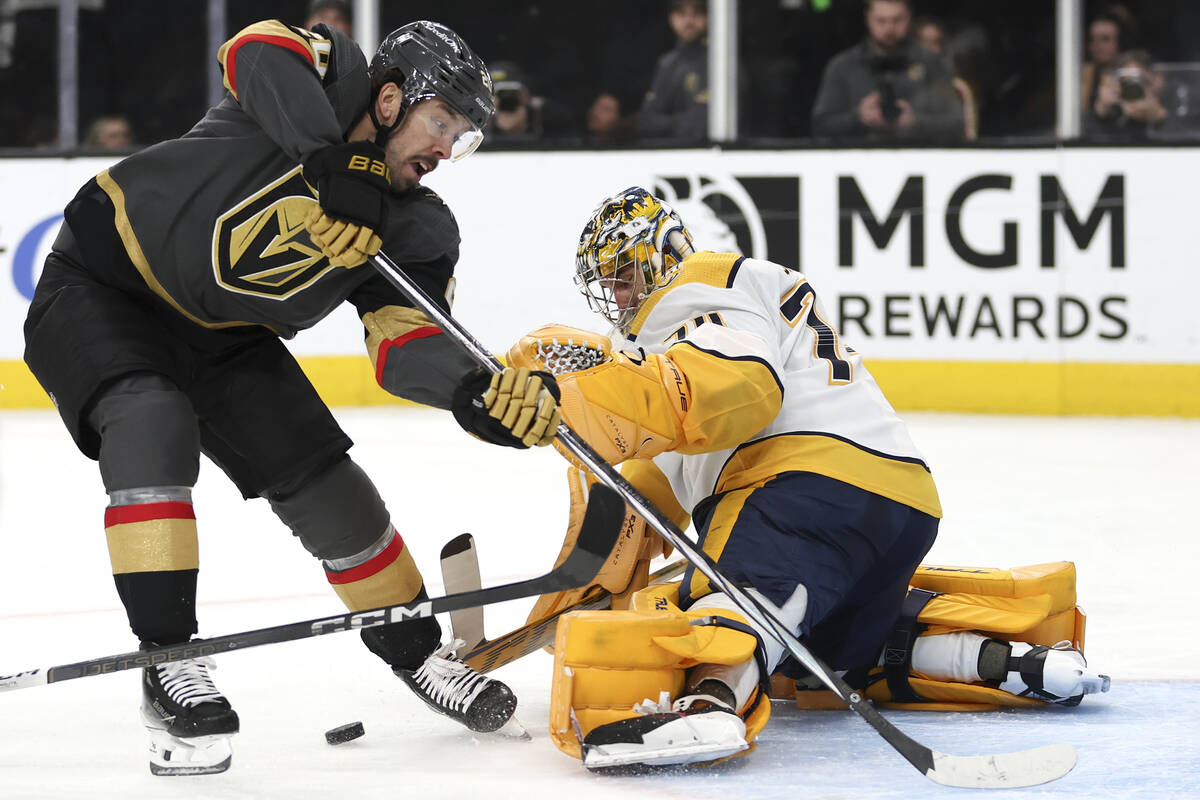 Vegas Golden Knights center Chandler Stephenson, left, attempts a goal while Nashville Predator ...