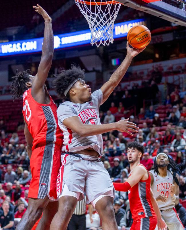 UNLV forward Rob Whaley Jr. (5) gets inside of New Mexico Lobos center Nelly Junior Joseph (23) ...