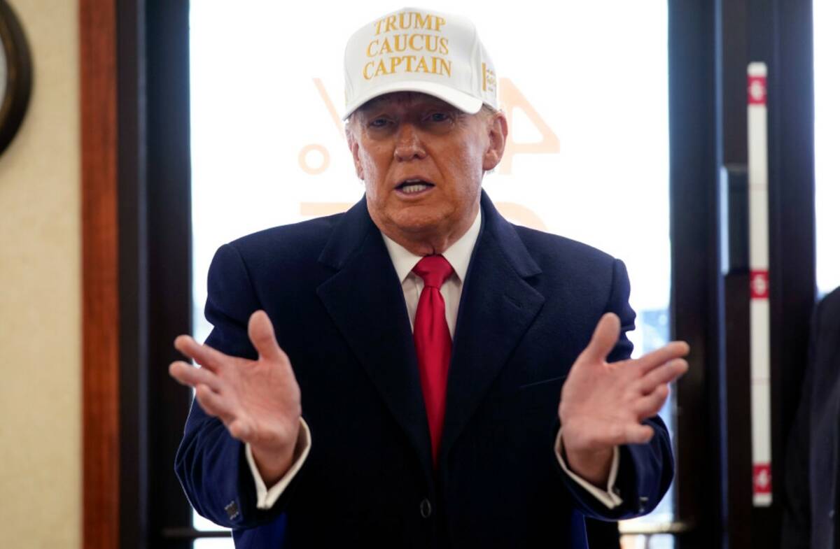 Donald Trump speaks as he arrives to pick up pizza at Casey's in Waukee, Iowa, Sunday, Jan. 14, ...