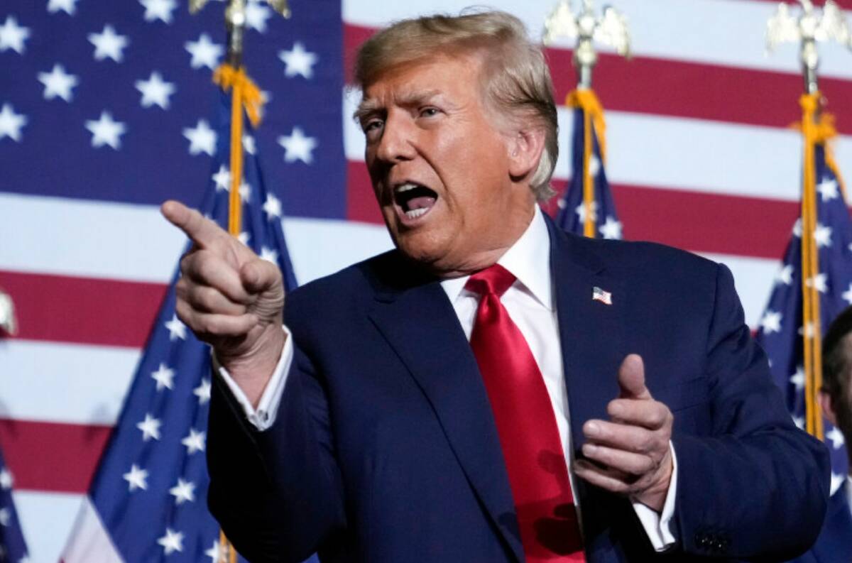 Donald Trump points to the crowd at a caucus night party in Des Moines, Iowa, Monday, Jan. 15, ...