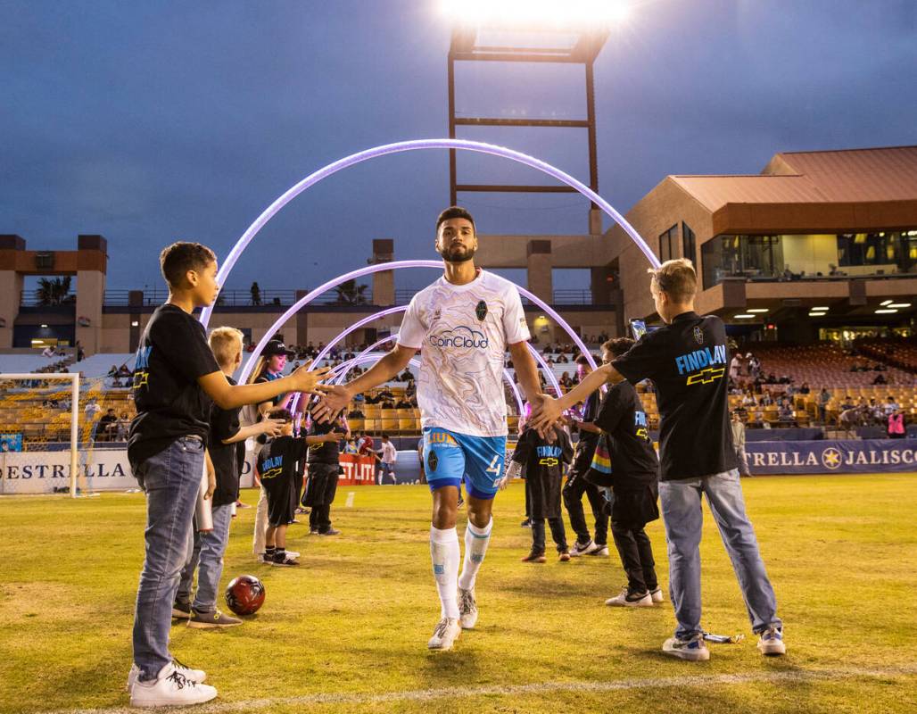 Alejandro Lara (4) enters the field during Lights' season opening game at Cashman Field on Satu ...