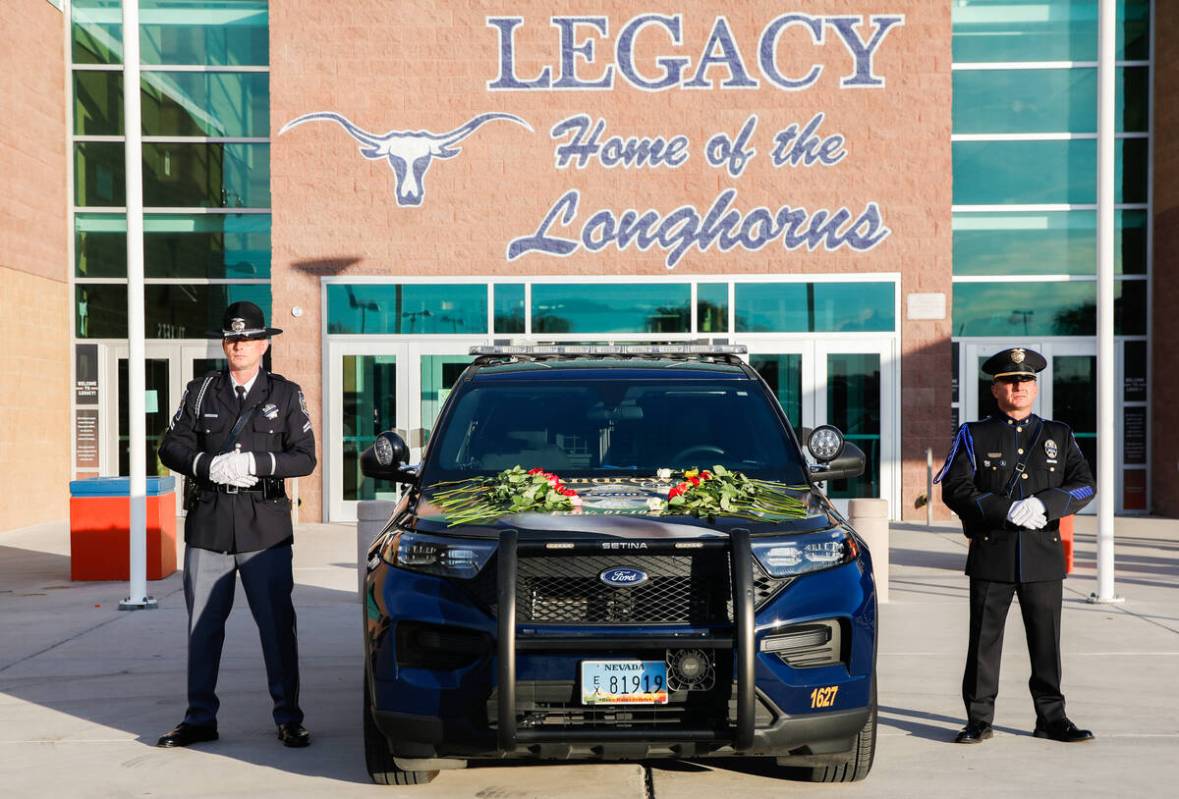 Officer Anthony Gaspardi, right, and Corporal James Guthrie stand beside the patrol vehicle of ...