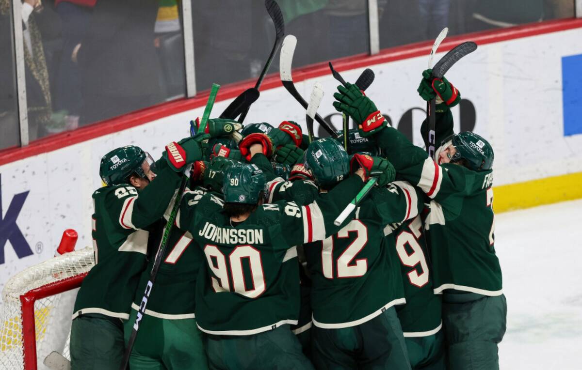 Minnesota Wild players surround goaltender Marc-Andre Fleury in celebration after winning again ...