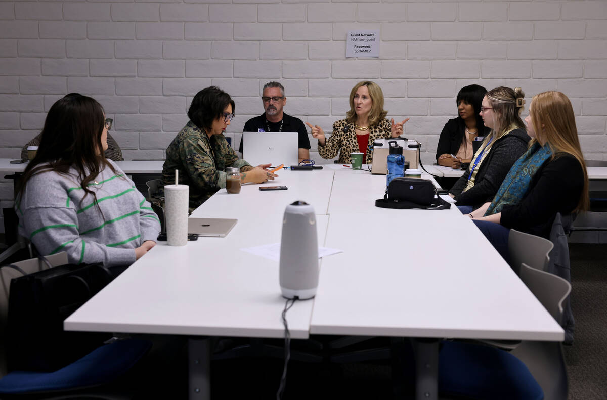 Julie Murray, co-chair of Hope Means Nevada, center rear, speaks during a youth mental health d ...