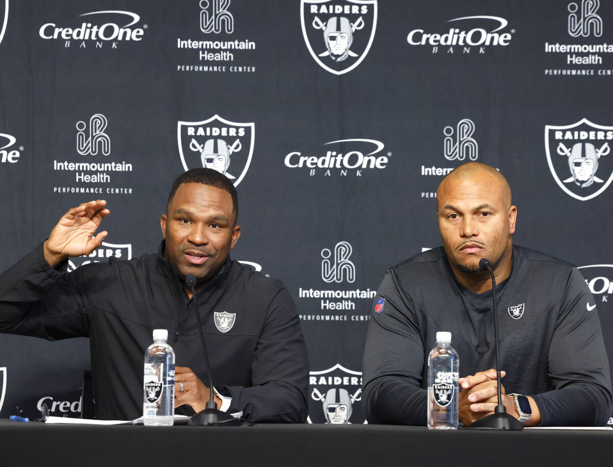 Champ Kelly, Raiders interim general manager, left, speaks during the press conference as Anton ...