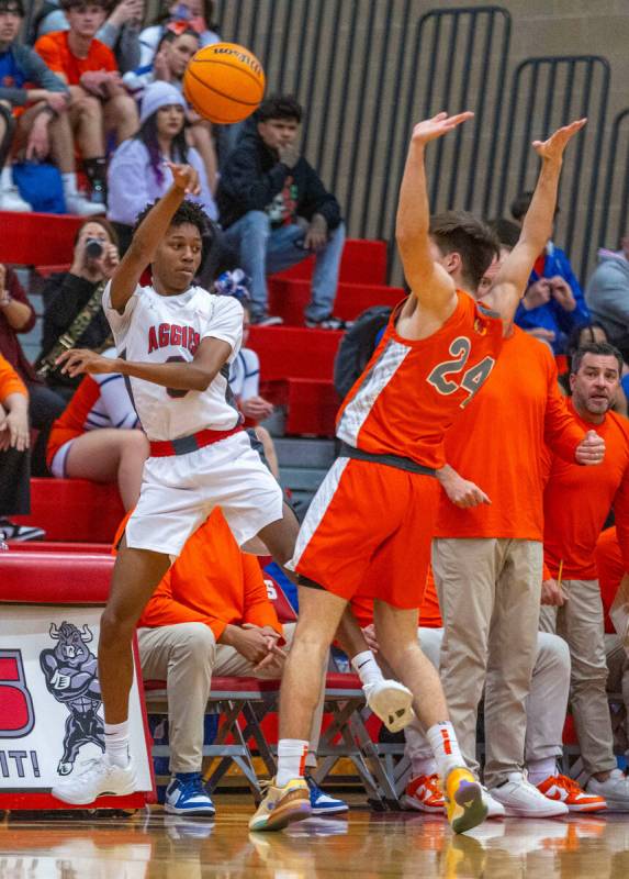 Arbor View guard DeMarion Yap (0) passes around Bishop Gorman guard Ryder Elisaldez (24) during ...