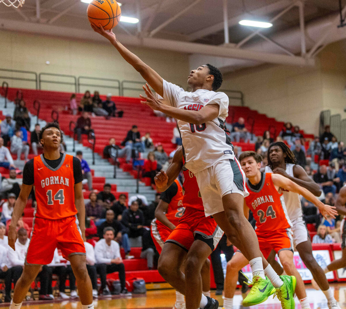 Arbor View guard Trammell Darden, Jr. (10) beats Bishop Gorman forward Jett Washington (2) to t ...