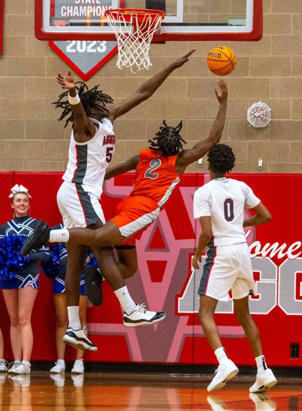 Bishop Gorman forward Jett Washington (2) falls away but gets off a shot on Arbor View forward ...