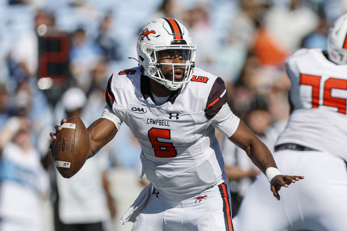 Campbell quarterback Hajj-Malik Williams scrambles in the second half of an NCAA college footba ...