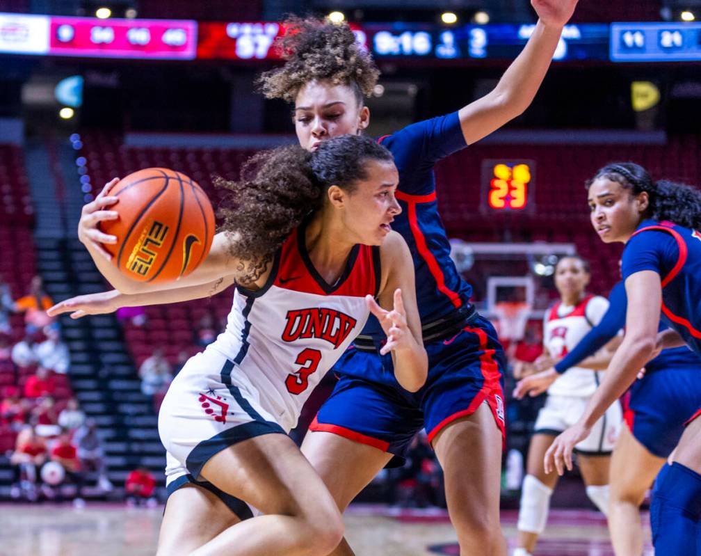 UNLV Lady Rebels guard Kiara Jackson (3) drives the lane on Arizona Wildcats guard Jada William ...