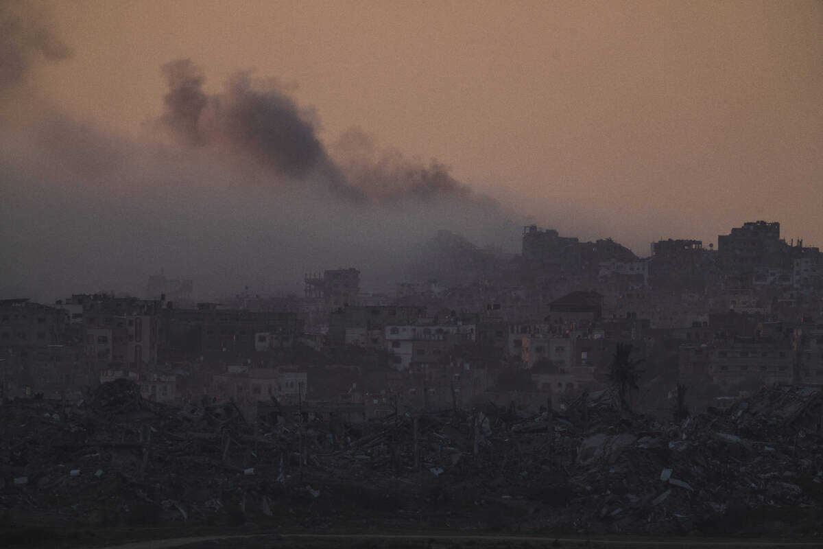 Smoke rises after an explosion in the Gaza Strip as seen from southern Israel, Tuesday, Jan. 16 ...