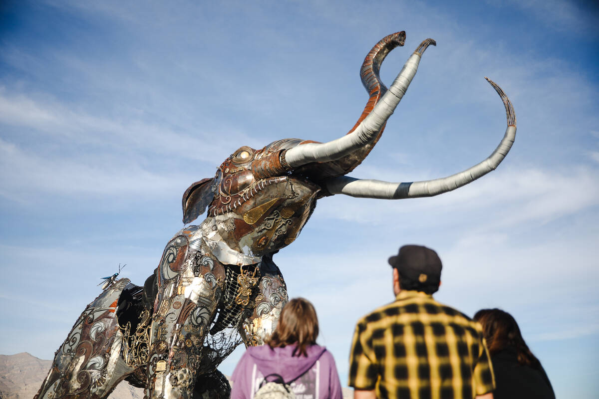 Guests observe artwork on display at Ice Age Fossils State Park in North Las Vegas, Tuesday, Ja ...