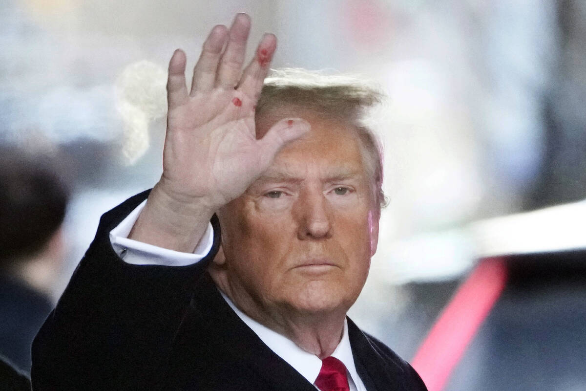 Former President Donald Trump waves as he leaves his apartment building in New York, Wednesday, ...