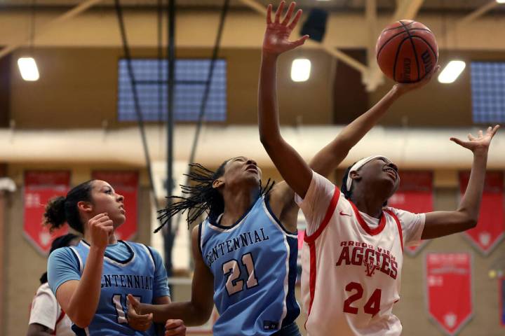 Centennial's Cici Ajomale (21) shoots against Arbor View's Sanai Branch (24) while Centennial's ...