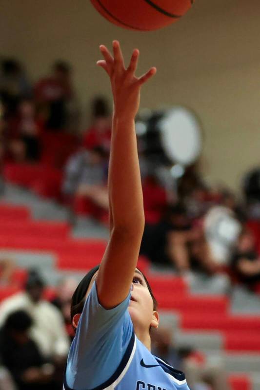 Centennial's Bella Crawford (00) hands in a layup during the second half of a high school baske ...