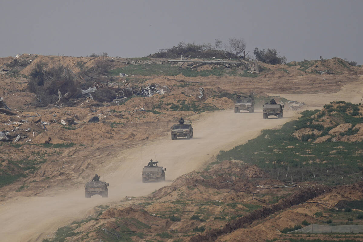 Israeli army vehicles move in the Gaza Strip near the Israeli-Gaza border as seen from southern ...