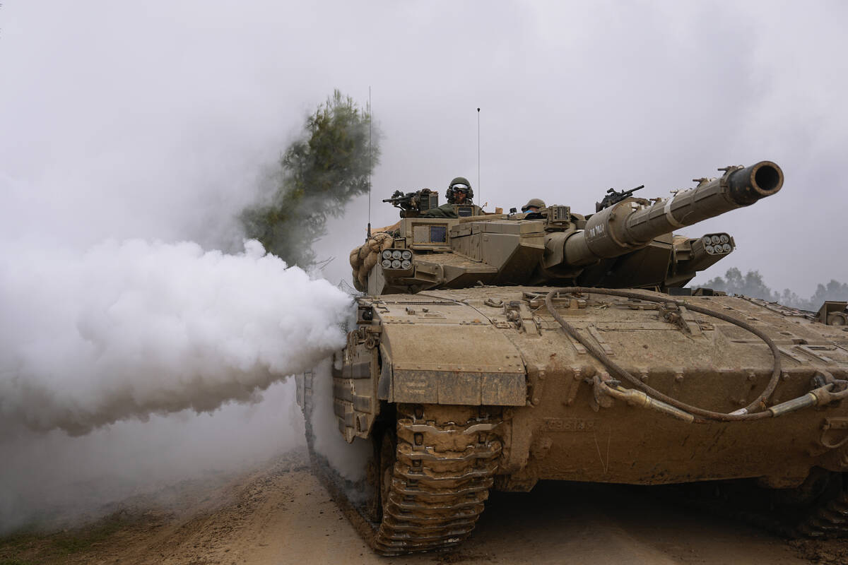 Israeli army tank moves near the Israeli-Gaza border, in southern Israel, Wednesday, Jan. 17, 2 ...