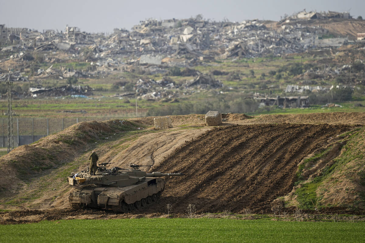 Israeli soldiers take up position along the Israeli-Gaza border, in southern Israel, Wednesday, ...