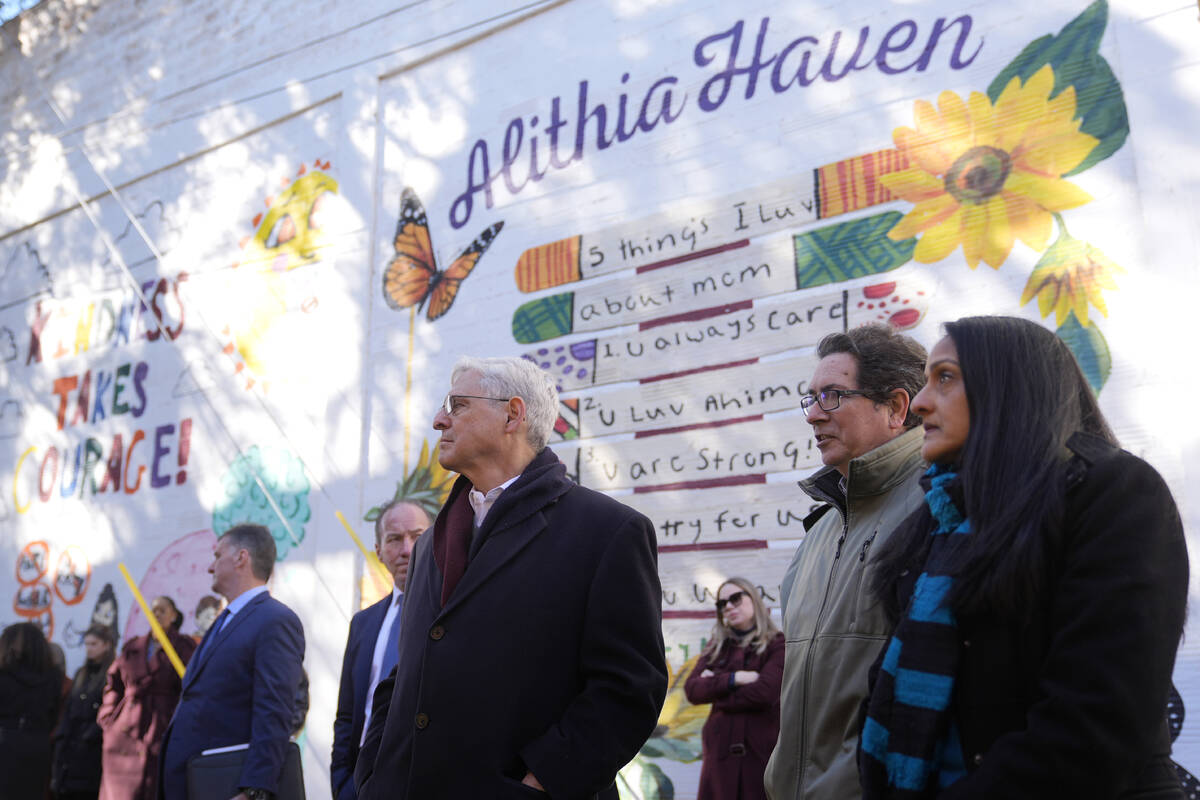 Artist Abel Ortiz, second from right, gives Attorney General Merrick Garland, center, and Assoc ...