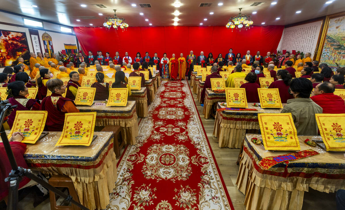 Holy Guru Zhengda Jiaozun, center, joins invited dignitaries in a ribbon cutting during the ope ...