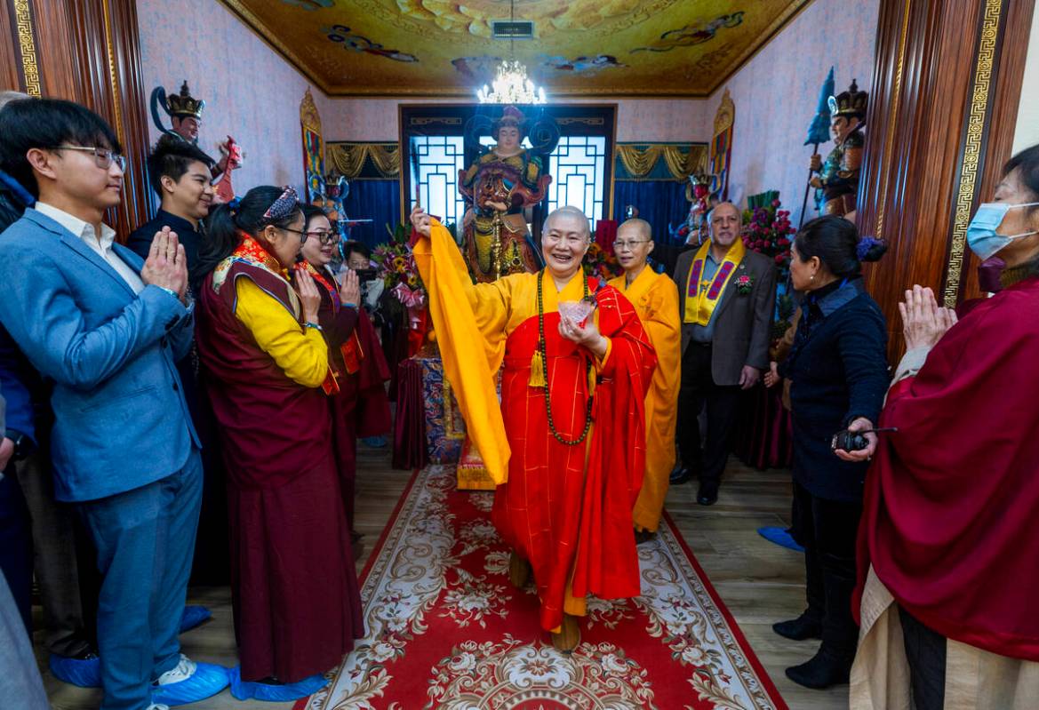 Holy Guru Zhengda Jiaozun sprinkles blessed water on attendees while joined by invited dignitar ...