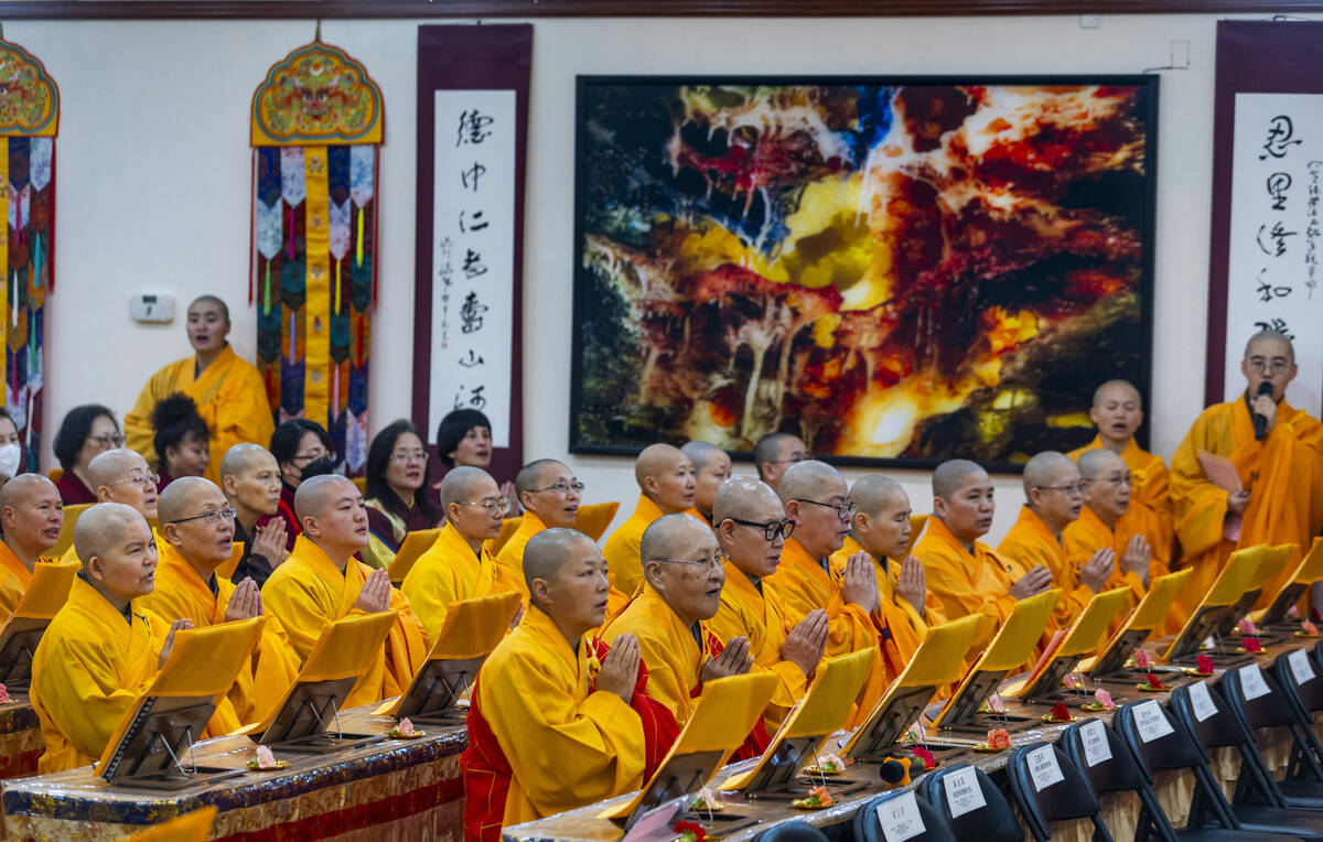 Monks pray during the opening ceremony of the Benevolence Temple on Thursday, Jan. 18, 2024, in ...