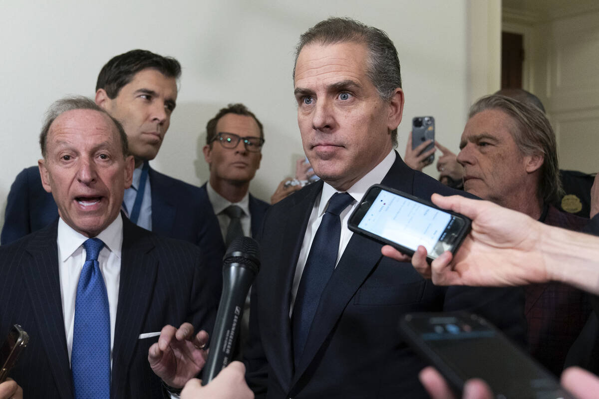 Hunter Biden, President Joe Biden's son, accompanied by his attorney Abbe Lowell, left, talks t ...