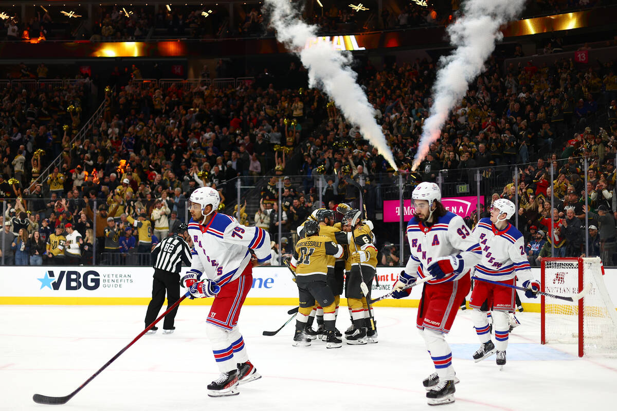 The Golden Knights celebrate center Ivan Barbashev’s goal while the Rangers skate towar ...