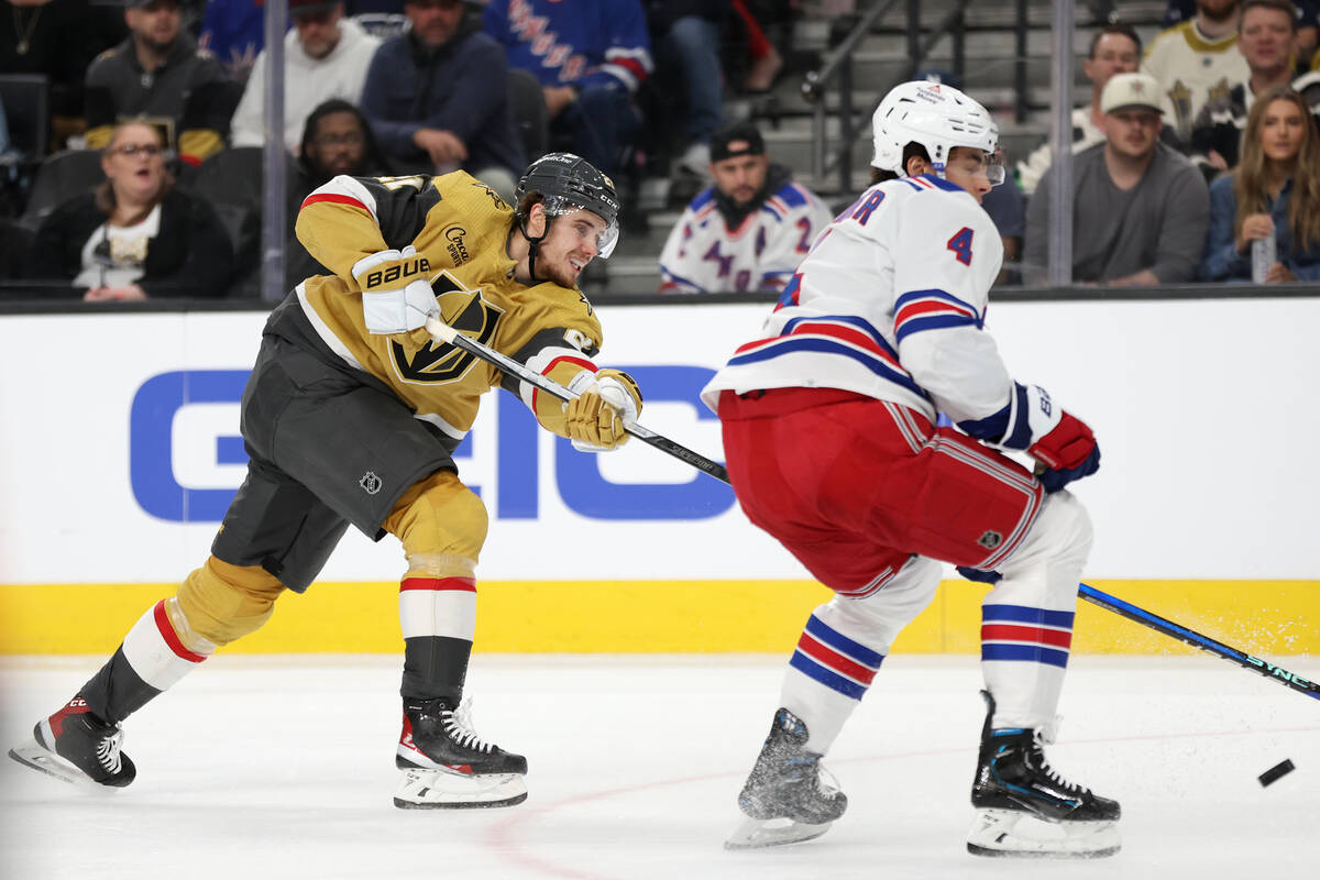 Golden Knights center Brett Howden (21) shoots past Rangers defenseman Braden Schneider (4) dur ...