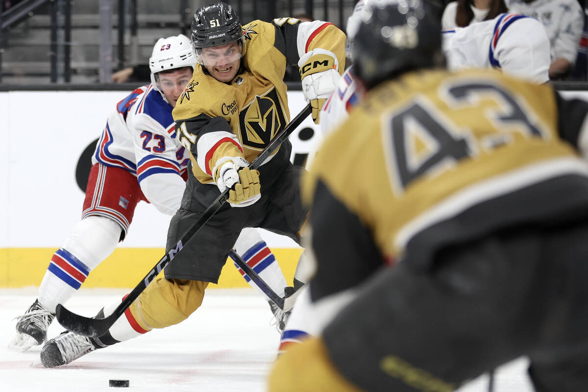 Golden Knights center Byron Froese (51) whips a pass to center Paul Cotter (43) while Rangers d ...